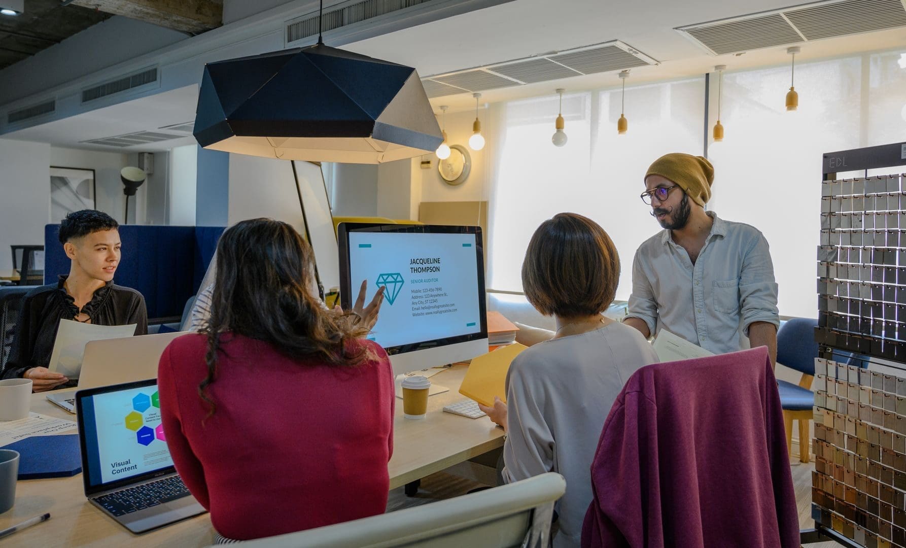 A diverse team collaborates in a modern office meeting, emphasizing teamwork and innovation.
